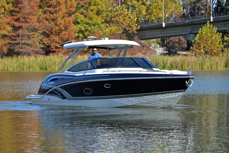 Slide: The Image of 2016 Formula 350 Crossover Bowrider cruising on a scenic lake with autumn foliage. - 7