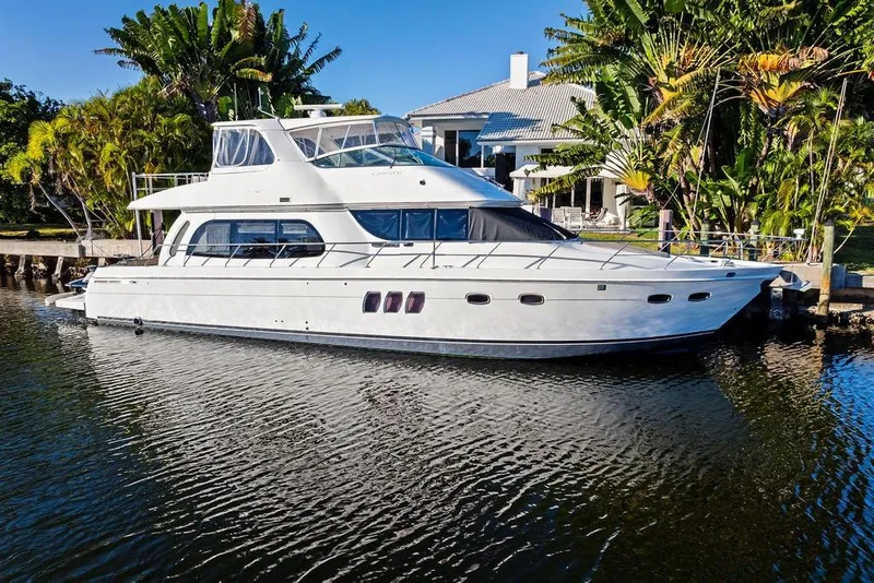 The Image of 2009 Carver 56 Voyager SE yacht docked by tropical waterfront home. - 0