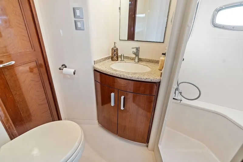 Slide: The Image of Luxurious bathroom in 2009 Carver 56 Voyager SE yacht with modern fixtures and wood accents. - 34