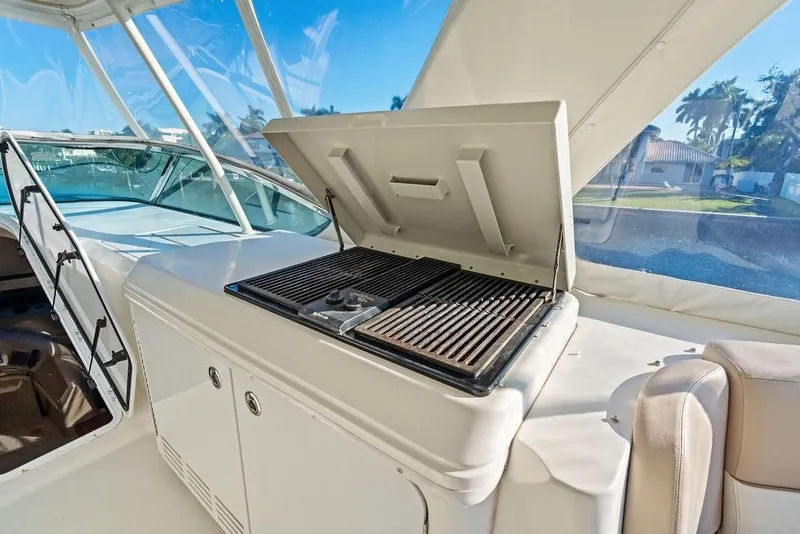 Slide: The Image of Outdoor grill on 2009 Carver 56 Voyager SE yacht deck, under clear blue sky. - 40