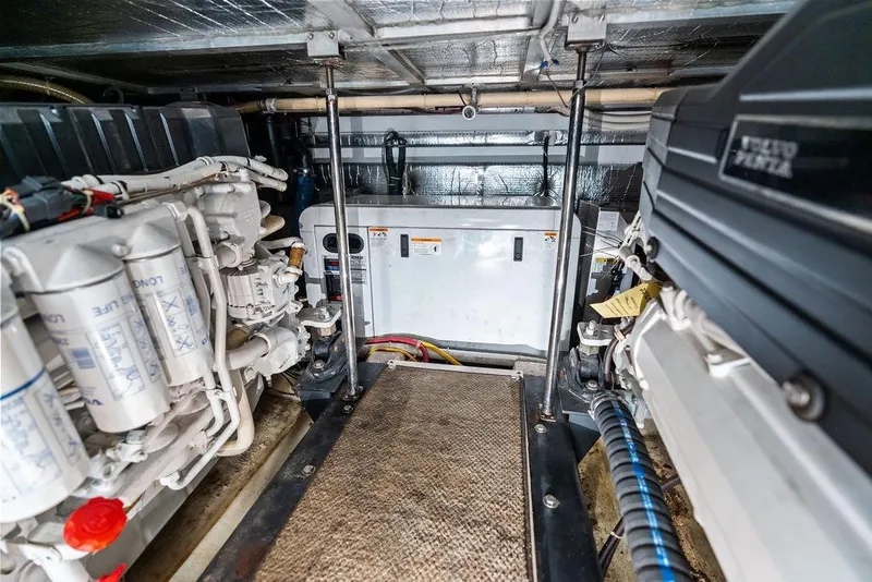 Slide: The Image of Engine room of a 2009 Carver 56 Voyager SE yacht, showcasing mechanical components. - 43