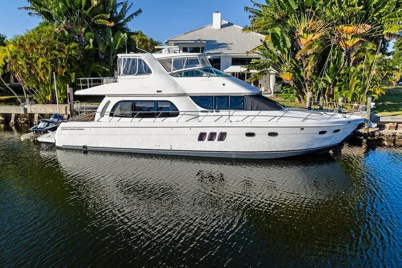 Slide: The Image of 2009 Carver 56 Voyager SE yacht docked by tropical waterfront home. - 8
