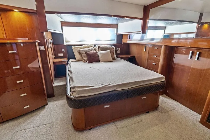Slide: The Image of Luxurious bedroom interior of 2009 Carver 56 Voyager SE yacht with elegant wood finish. - 25
