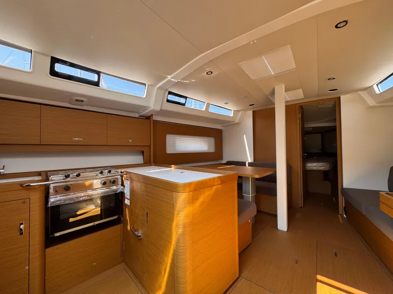 Slide: The Image of 2024 Beneteau First 44 yacht interior with modern kitchen and seating area. - 17