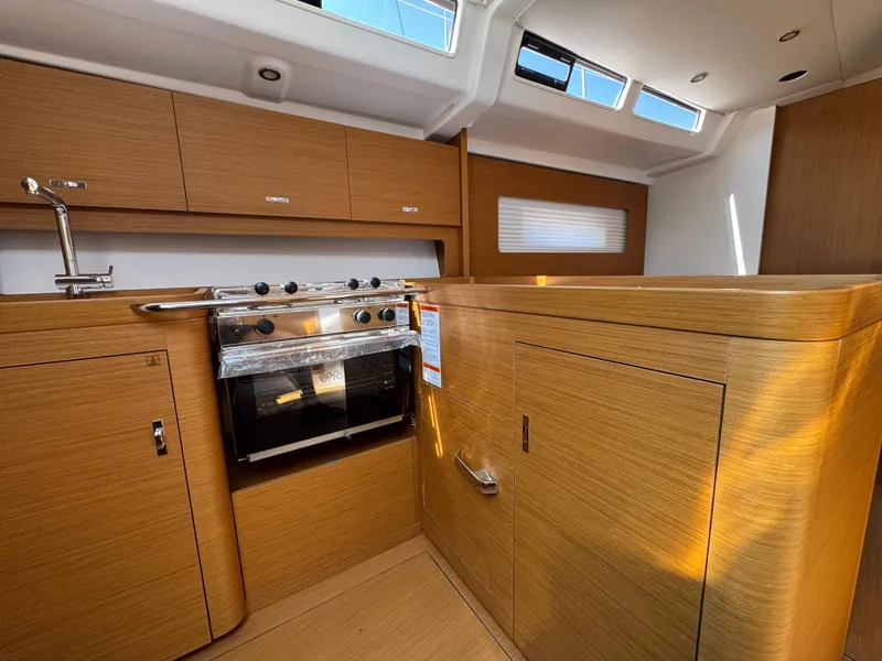 Slide: The Image of Modern kitchen interior of 2024 Beneteau First 44 yacht with wood finish and stainless steel appliances. - 18