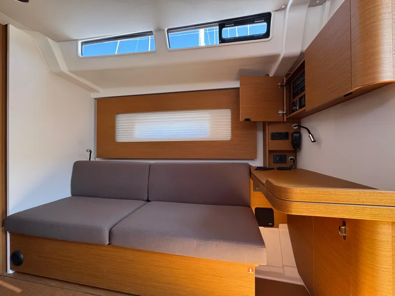 Slide: The Image of 2024 Beneteau First 44 interior with modern wood finish and comfortable seating. - 19