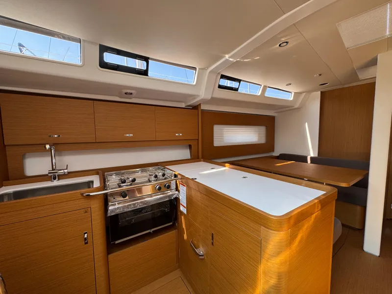 Slide: The Image of 2024 Beneteau First 44 yacht interior with modern kitchen and dining area. - 20
