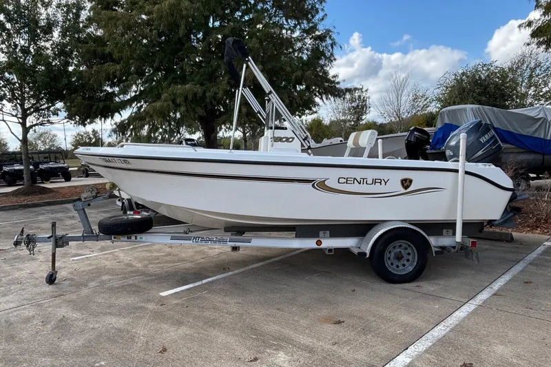 Slide: The Image of 2004 Century 1800 Center Console boat on trailer in parking lot. - 0