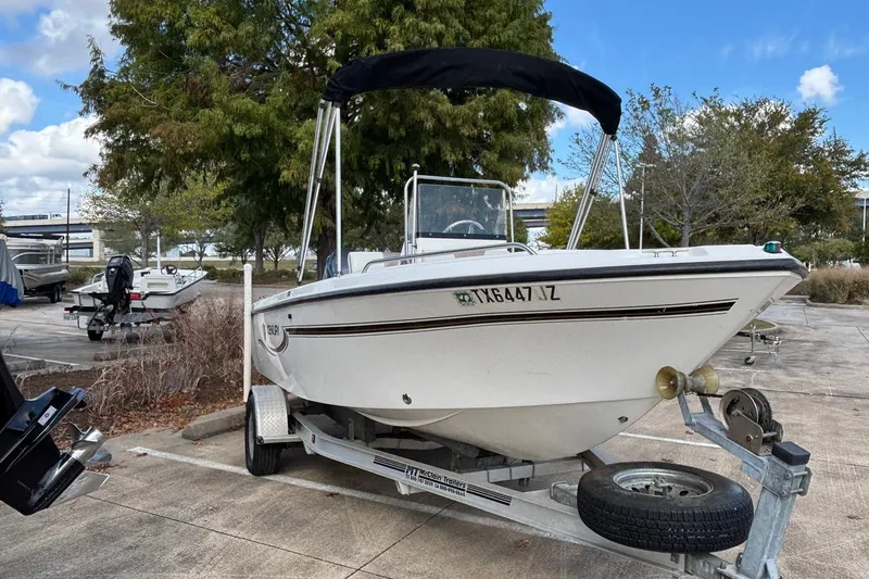 Slide: The Image of 2004 Century 1800 Center Console boat on trailer in outdoor setting. - 1