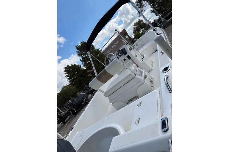 Slide: The Image of 2004 Century 1800 Center Console boat interior with seating and control panel. - 2