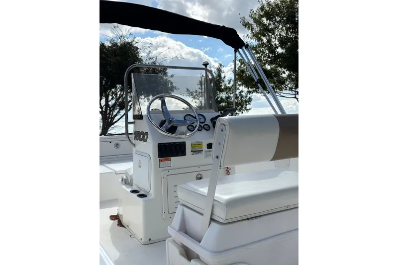 Slide: The Image of 2004 Century 1800 Center Console boat interior with steering wheel and seating. - 4