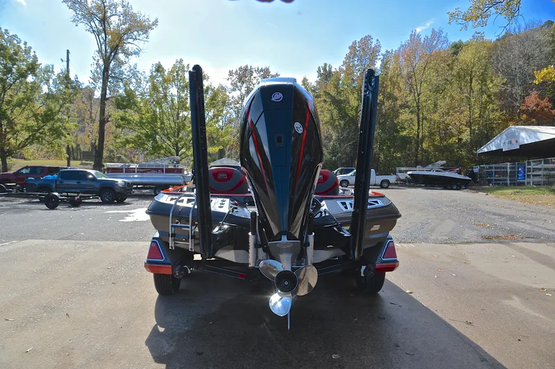 Slide: The Image of 2020 Ranger Z521L boat with powerful outboard motor, parked outdoors on a sunny day. - 13