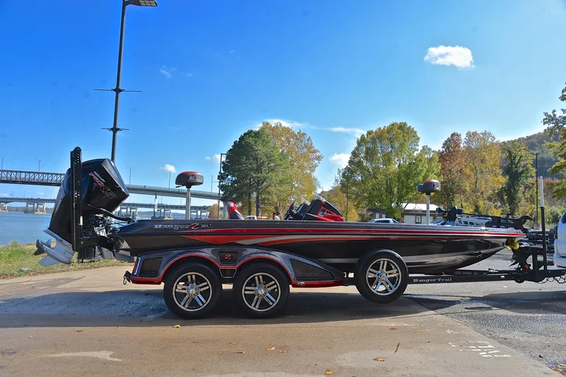 Slide: The Image of 2020 Ranger Z521L boat on trailer by river, clear sky, autumn trees. - 15