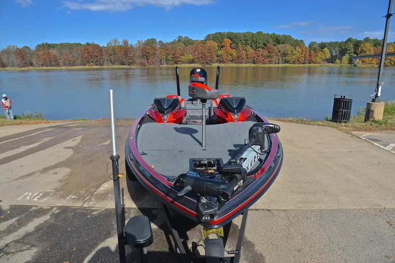 Slide: The Image of 2020 Ranger Z521L boat at a lakeside ramp with autumn trees in the background. - 17