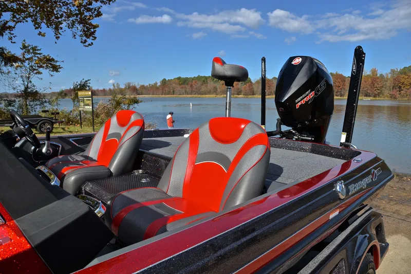 Slide: The Image of 2020 Ranger Z521L boat with red seats by a scenic lake. - 18
