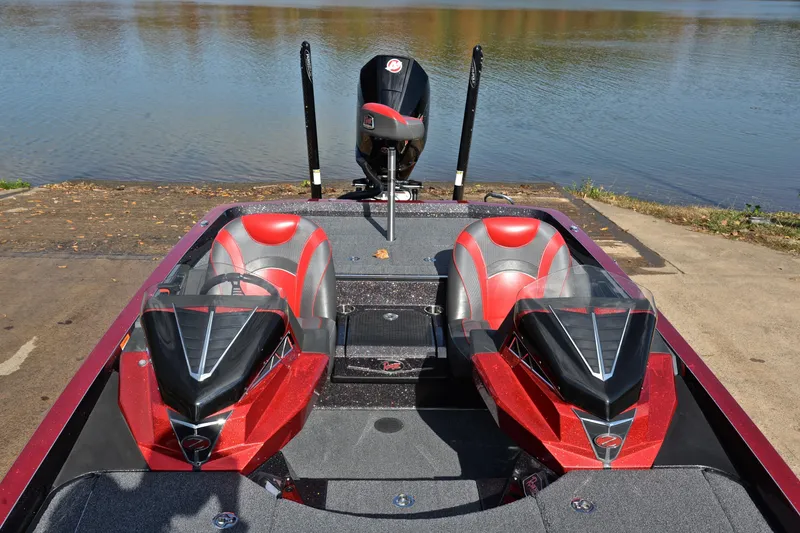 Slide: The Image of 2020 Ranger Z521L boat with red and gray seats, docked by a lake. - 21