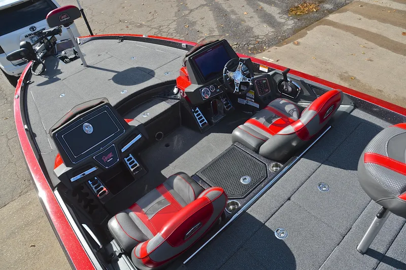 Slide: The Image of 2020 Ranger Z521L boat interior with red and gray seats, advanced dashboard, and spacious deck. - 23