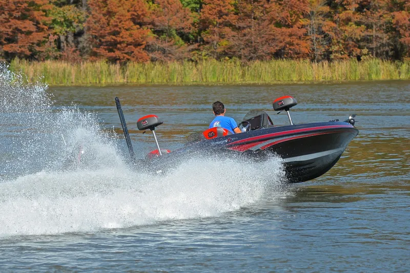 Slide: The Image of 2020 Ranger Z521L boat speeding on a lake with autumn trees in the background. - 5