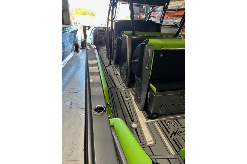 Slide: The Image of 2026 Nor-Tech 390 Sport Center Console with sleek design and vibrant green accents. - 2
