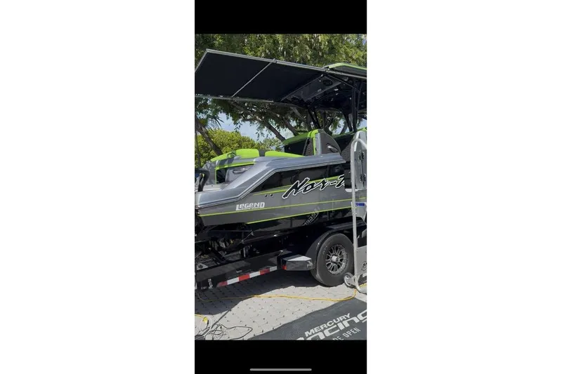 Slide: The Image of 2026 Nor-Tech 390 Sport Center Console boat with sleek design and vibrant accents. - 4