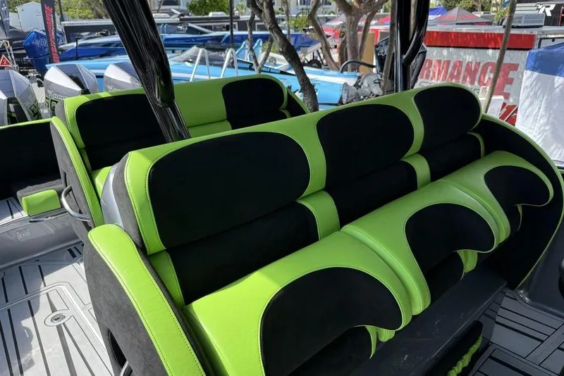 Slide: The Image of 2026 Nor-Tech 390 Sport Center Console with vibrant green and black seating. - 5