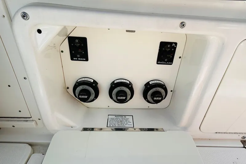 Slide: The Image of Control panel of a 2005 Century 3200 Center Console boat with switches and dials. - 12