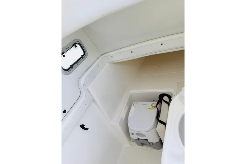 Slide: The Image of Interior of 2005 Century 3200 Center Console boat with compact toilet and window. - 15