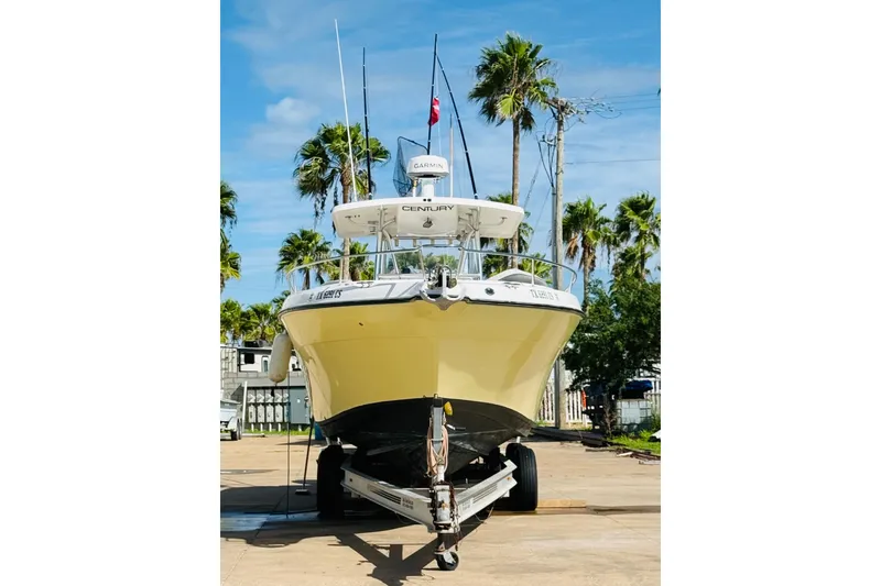 Slide: The Image of 2005 Century 3200 Center Console boat on trailer, surrounded by palm trees. - 4