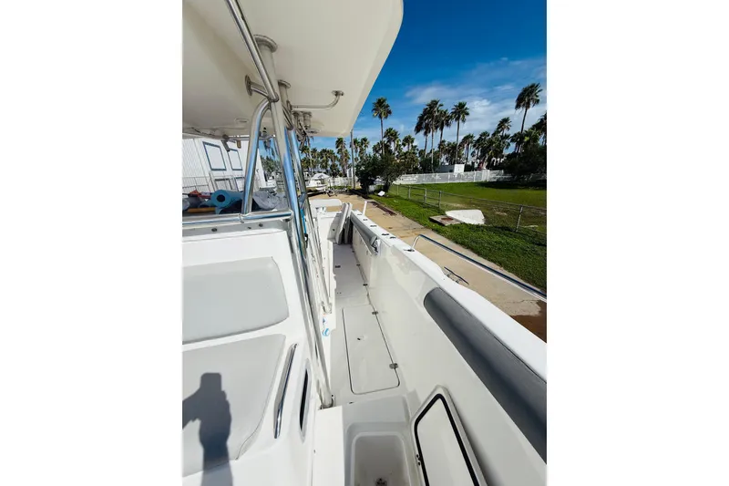 Slide: The Image of 2005 Century 3200 Center Console boat with spacious deck, palm trees in background. - 8
