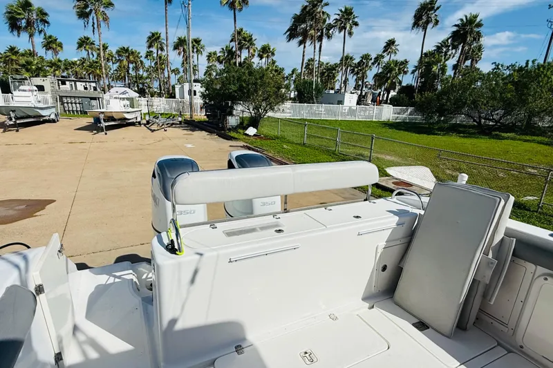 Slide: The Image of 2005 Century 3200 Center Console boat with dual 350 engines, parked outdoors. - 9