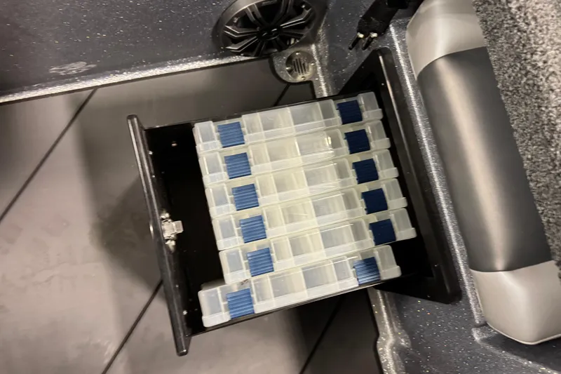 Slide: The Image of Storage compartment in 2026 Nitro ZV19 Sport Pro boat with organized tackle boxes. - 18