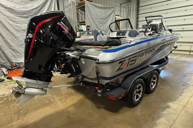Slide: The Image of 2026 Nitro ZV19 Sport Pro boat with powerful outboard motor in a garage setting. - 2