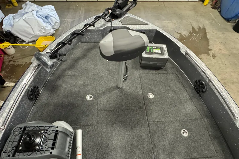 Slide: The Image of 2026 Nitro ZV19 Sport Pro boat interior with Garmin equipment and carpeted deck. - 26