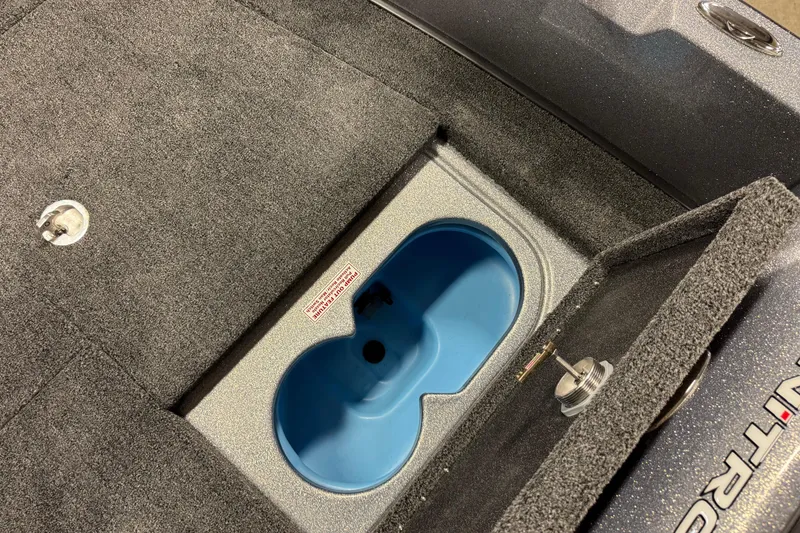 Slide: The Image of 2026 Nitro ZV19 Sport Pro boat interior with storage compartment and blue insert. - 27