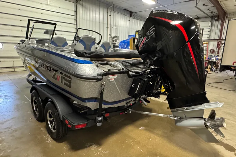 Slide: The Image of 2026 Nitro ZV19 Sport Pro boat with powerful outboard motor in a garage setting. - 3