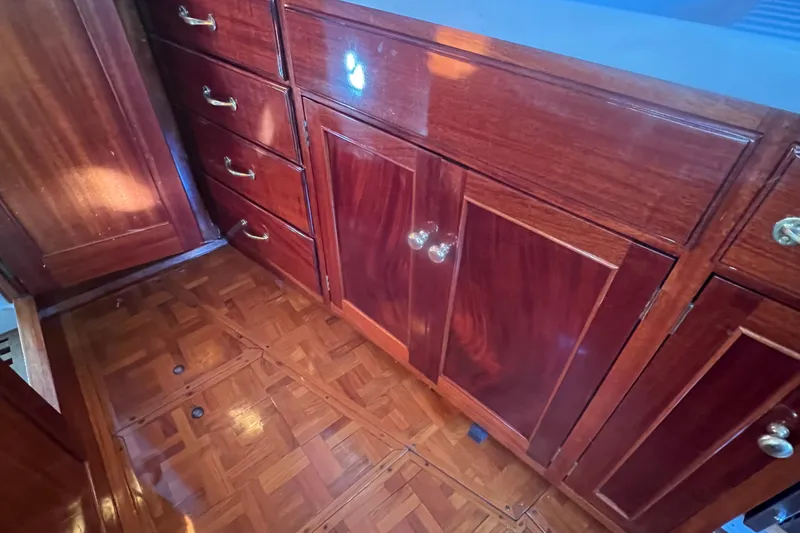 Slide: The Image of Polished wooden cabinetry and parquet flooring inside a 1966 Moody Salar Motorsailer. - 16