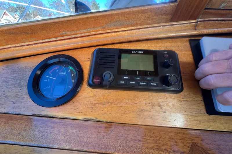 Slide: The Image of Wooden boat dashboard with wind gauge and Garmin device, Moody Cutter 1966. - 23