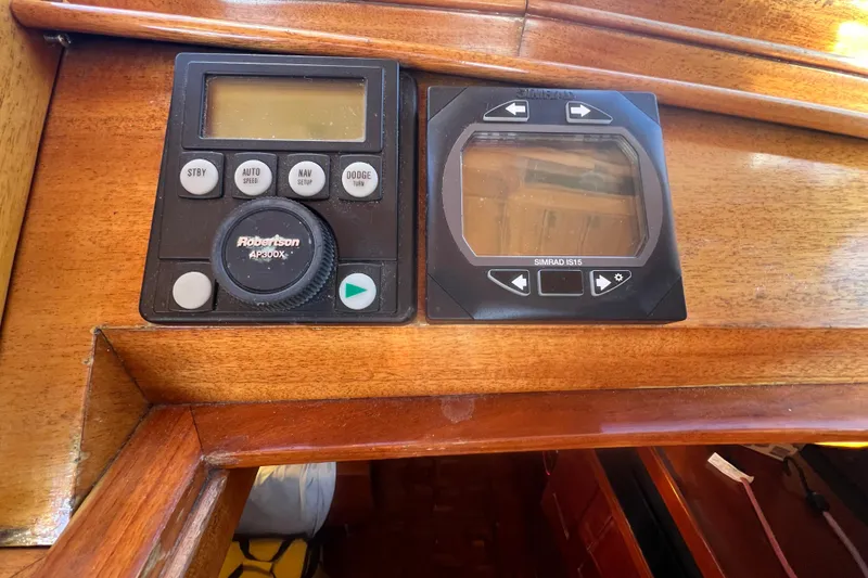 Slide: The Image of Control panel on a 1966 Moody Cutter sailboat, featuring Robertson AP300X and Simrad IS15 displays. - 25