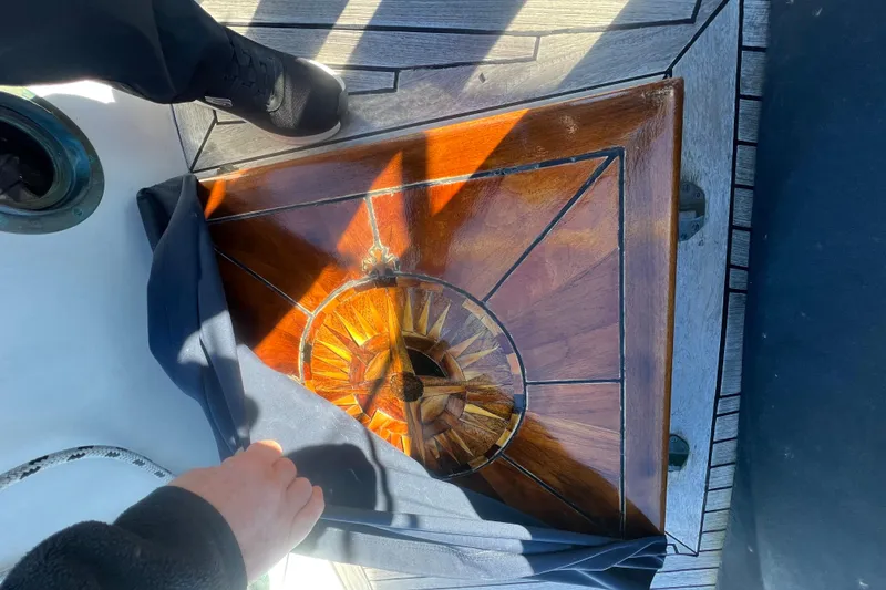 Slide: The Image of Wooden hatch on 1966 Moody Cutter sailboat, featuring intricate sunburst design. - 28