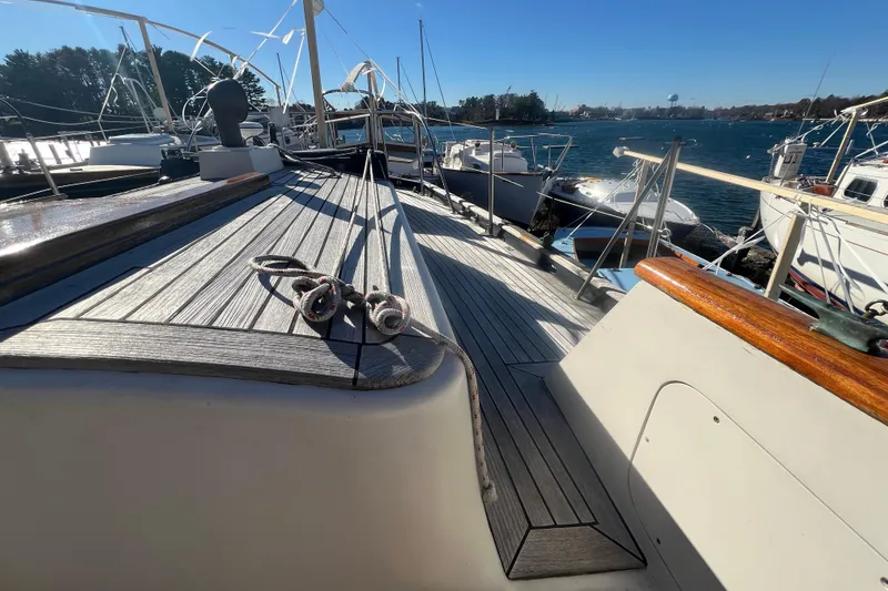 Slide: The Image of 1966 Moody Cutter sailboat deck with ropes, docked in a sunny marina. - 31
