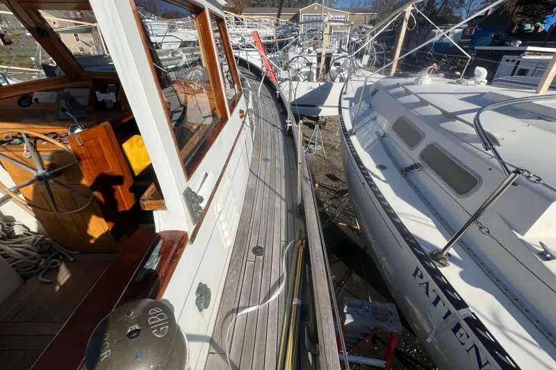 Slide: The Image of 1966 Moody Cutter sailboat docked alongside another vessel in a marina. - 33