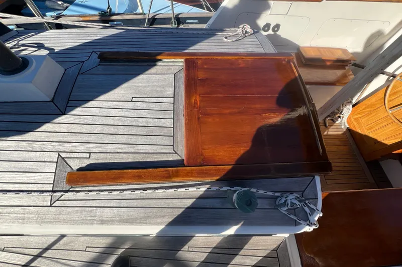 Slide: The Image of 1966 Moody Cutter sailboat deck with polished wood and nautical ropes. - 37