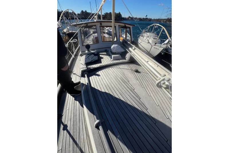 Slide: The Image of 1966 Moody Cutter sailboat deck with wooden finish, docked at marina. - 39