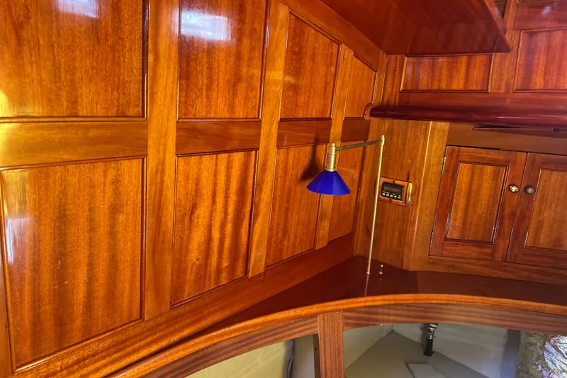 Slide: The Image of Polished wooden interior of a 1966 Moody Cutter boat with blue lamp. - 4