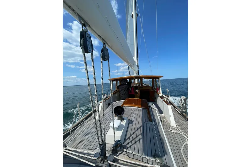 Slide: The Image of 1966 Moody Salar Motorsailer with cutter rig sailing on open sea under clear skies. - 44