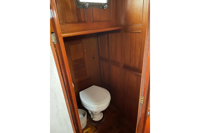 Slide: The Image of Wood-paneled bathroom in 1966 Moody Salar Motorsailer yacht, featuring a compact toilet. - 8