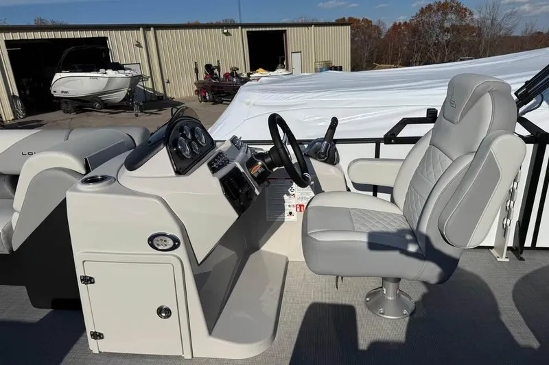 Slide: The Image of 2026 Lowe SF 232 Sport Fish boat interior with steering console and captain's chair. - 13