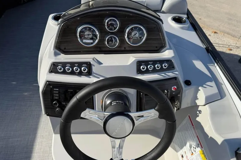 Slide: The Image of 2026 Lowe SF 232 Sport Fish boat dashboard with steering wheel and gauges. - 14