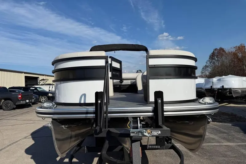Slide: The Image of 2026 Lowe SF 232 Sport Fish pontoon boat on trailer under clear sky. - 2