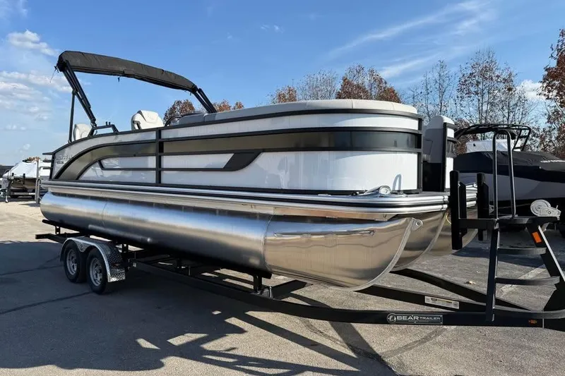 Slide: The Image of 2026 Lowe SF 232 Sport Fish pontoon boat on trailer, parked outdoors. - 3